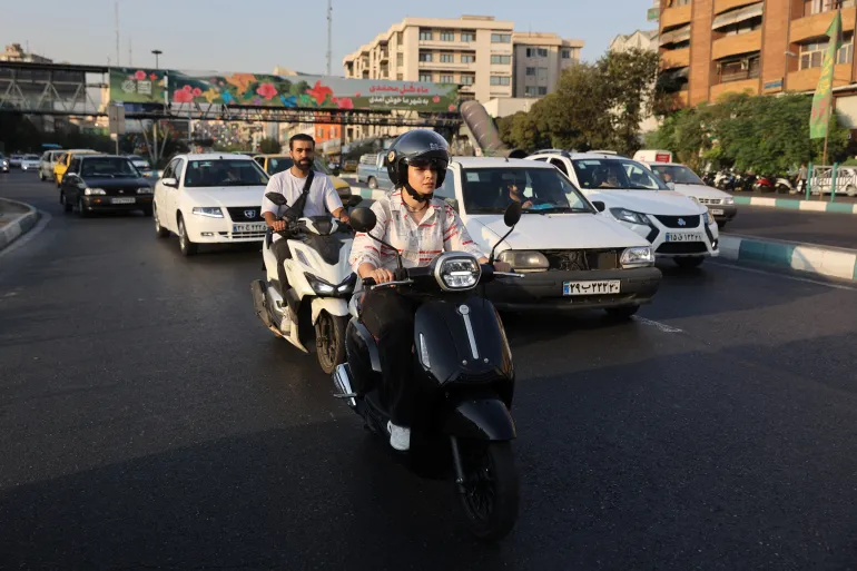 Iranian woman, Bahareh, rides a motorcycle without a licence in Tehran on September 8, 2025 [Majid Asgaripour/WANA via Reuters]