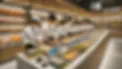 DALL·E 2024-12-26 11.39.57 - A sushi kiosk inside a supermarket with a chef training staff