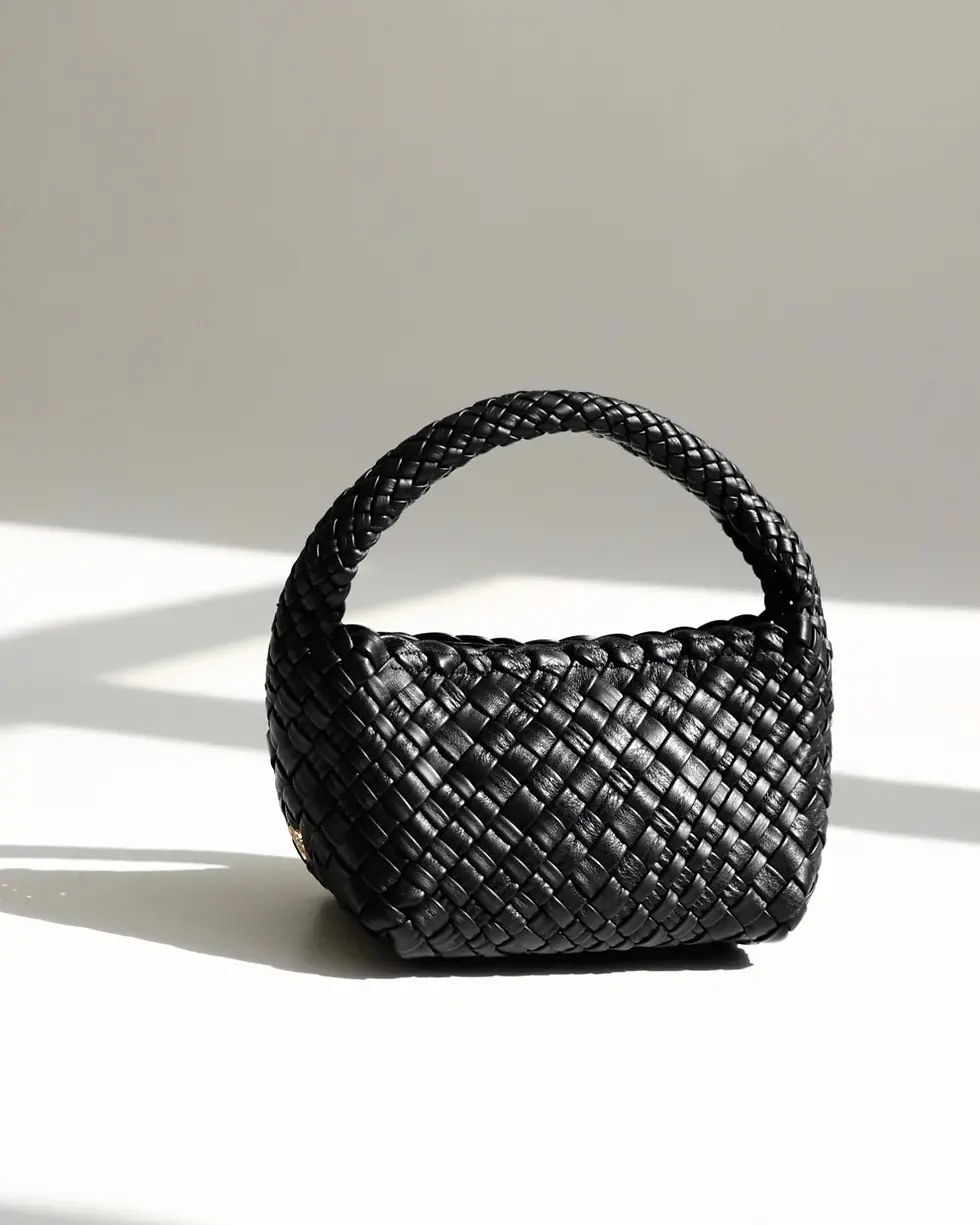 Thumbnail: Side View Of A Black Woven Leather Top Handle Bag
