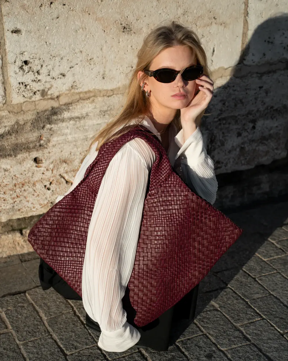 Lifestyle View Of A Bordeaux Woven Leather Shoulder Bag  Made In Italy
