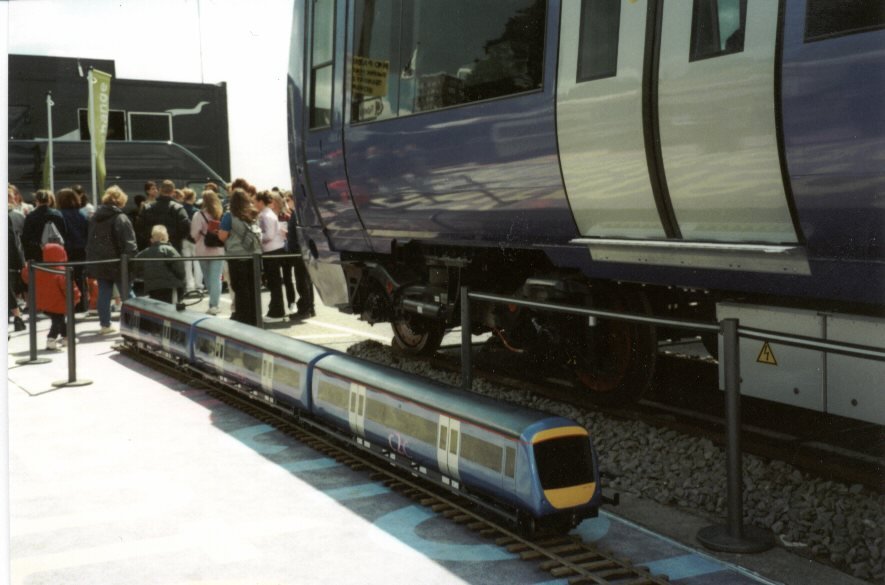 Class 357 miniature displayed alongside a full size c2c train