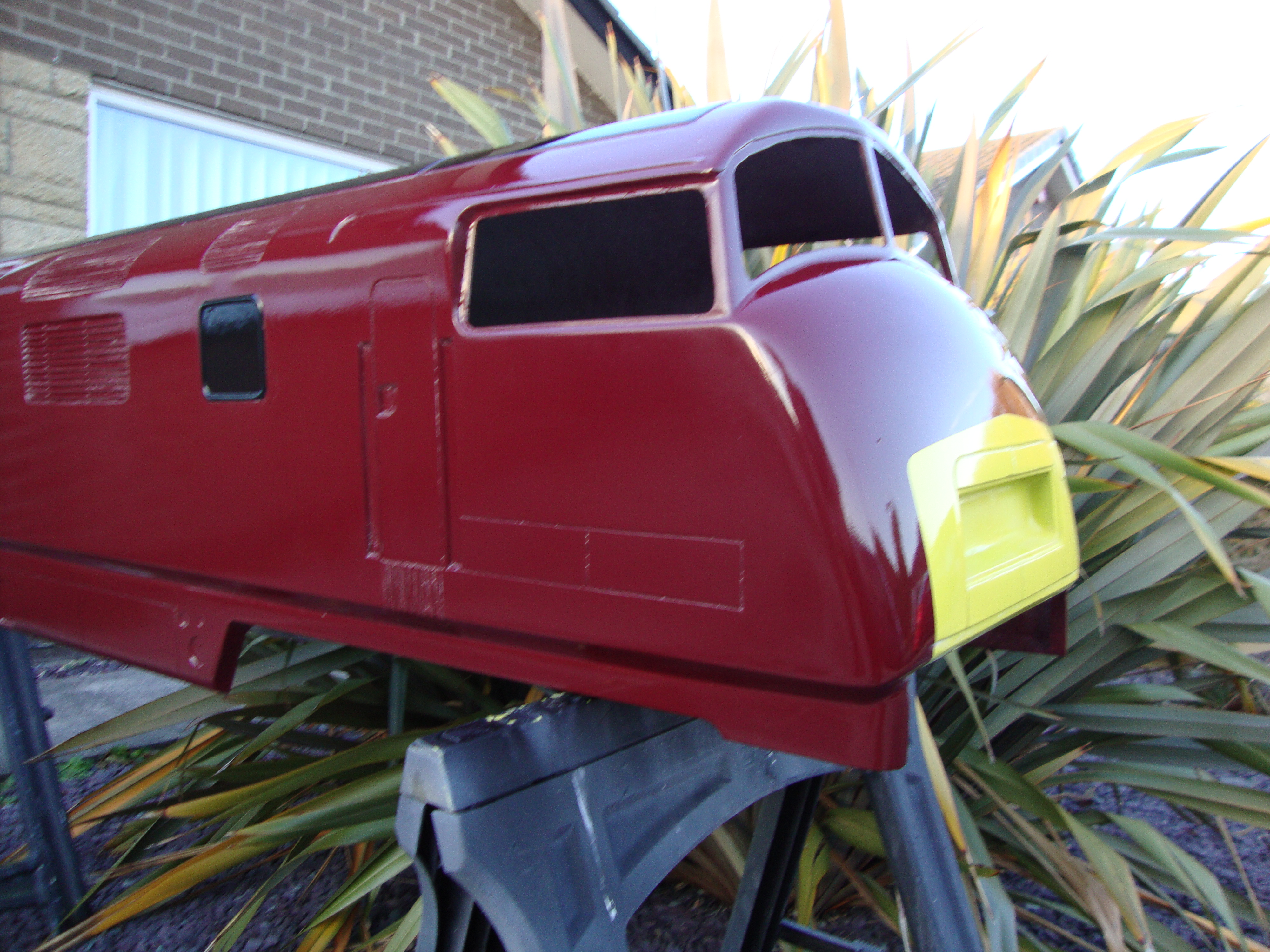 The maroon Warship body, showing the cab front and yellow warning panel.