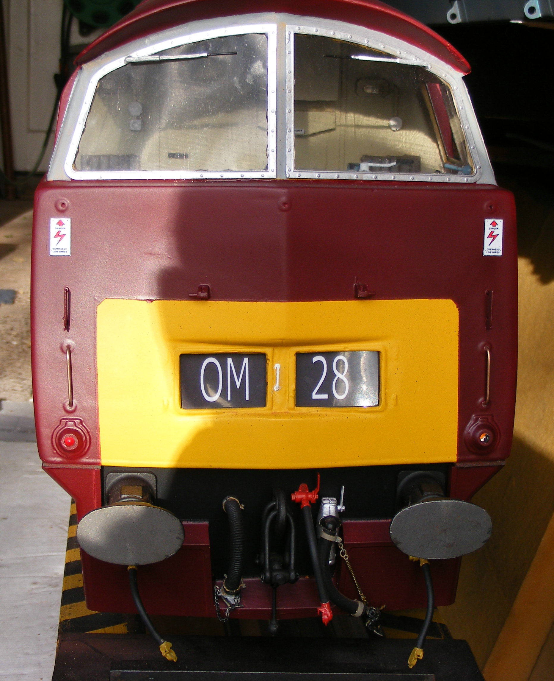 A maroon Western cab front, with headcode 0M28.