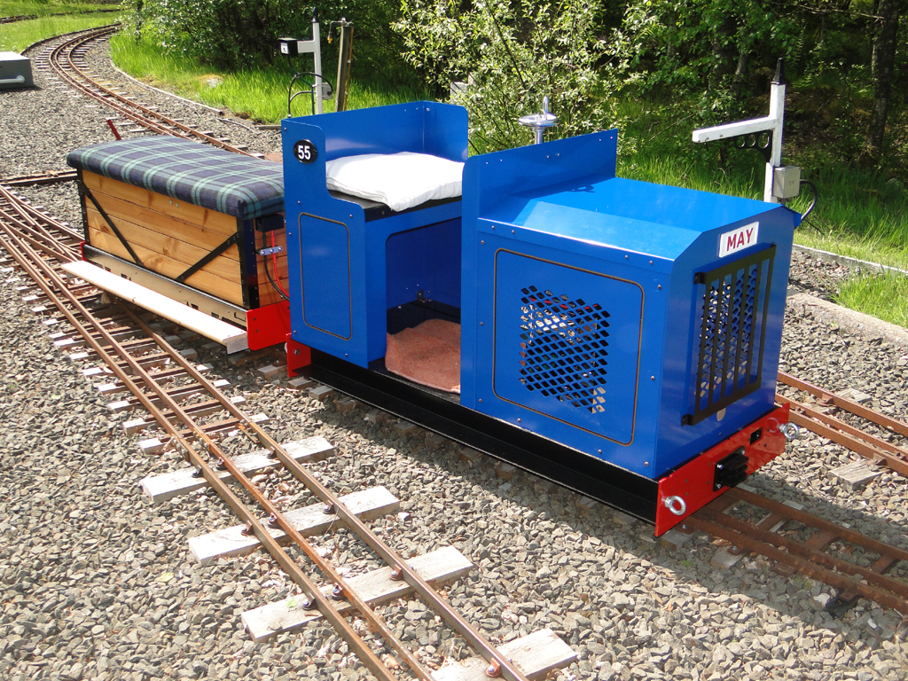 Blue Phoenix Tug miniature locomotive with a matching driving truck on miniature railway track
