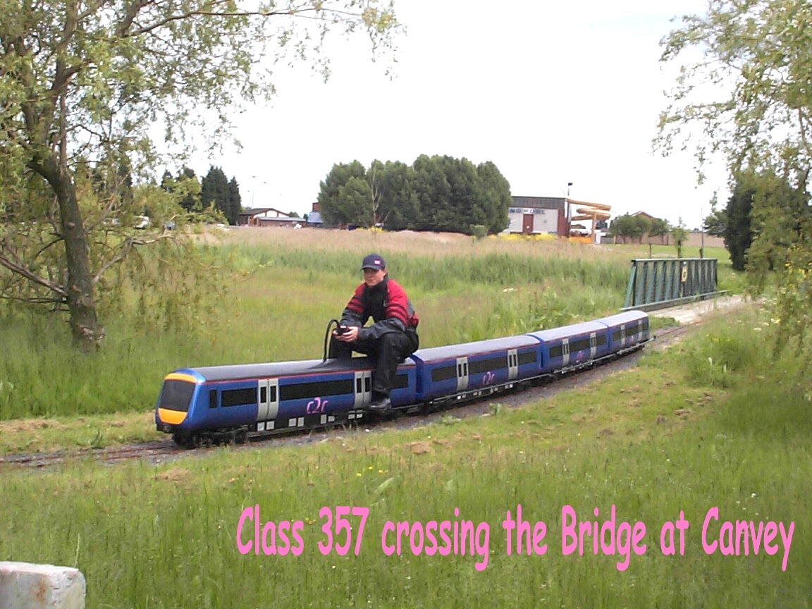 Blue c2c Class 357 miniature crossing a bridge at Canvey