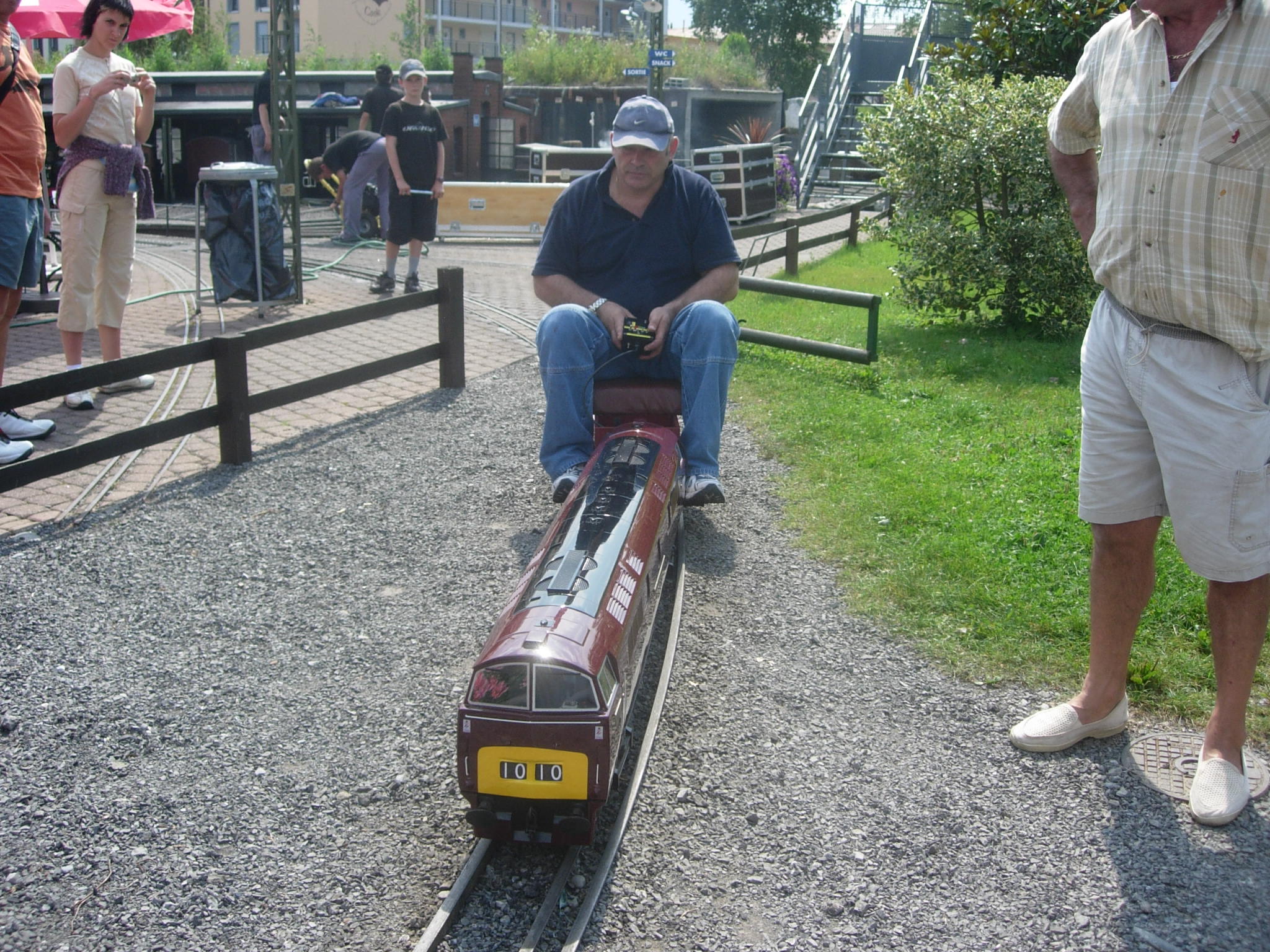 A maroon Western hauling a passenger train.