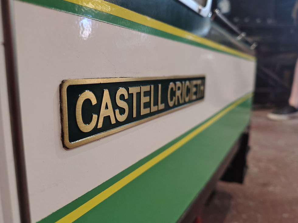 Close up of the Castell Cricieth Name plate after cleaning, polishing and a repaint.