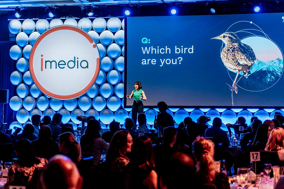 Amantha Imber speaking on stage at a workplace performance event
