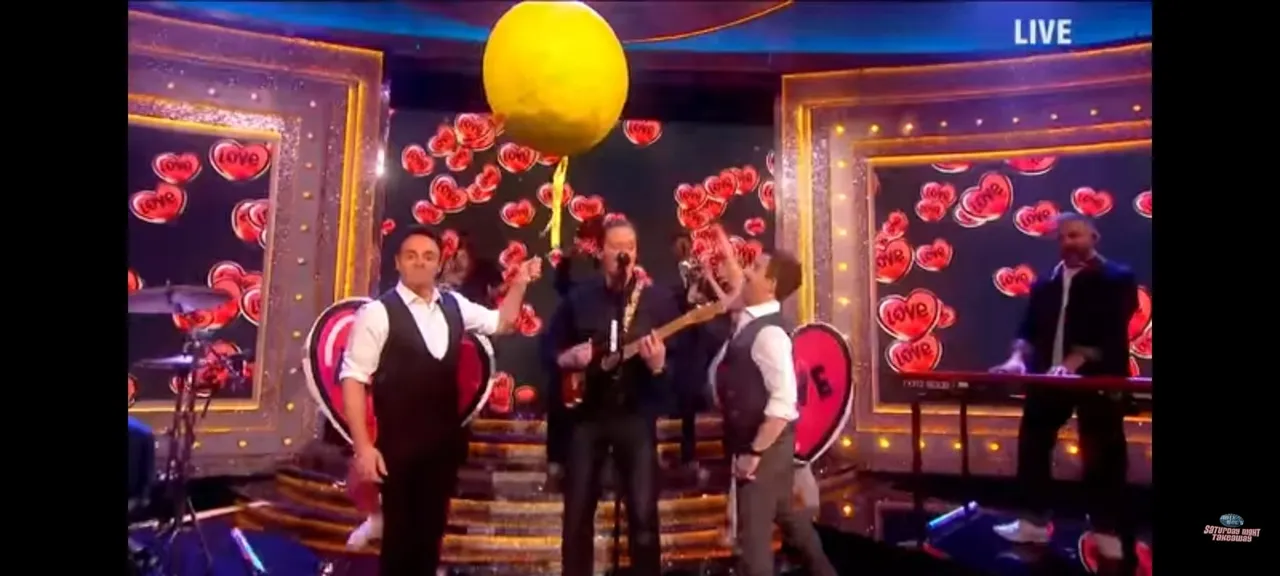 ant and dec saturday night take away with large yellow confetti filled balloons to pop on george erza head