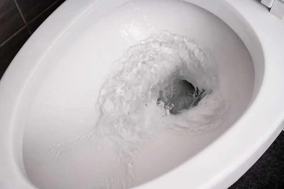 White toilet in the middle of flushing 
