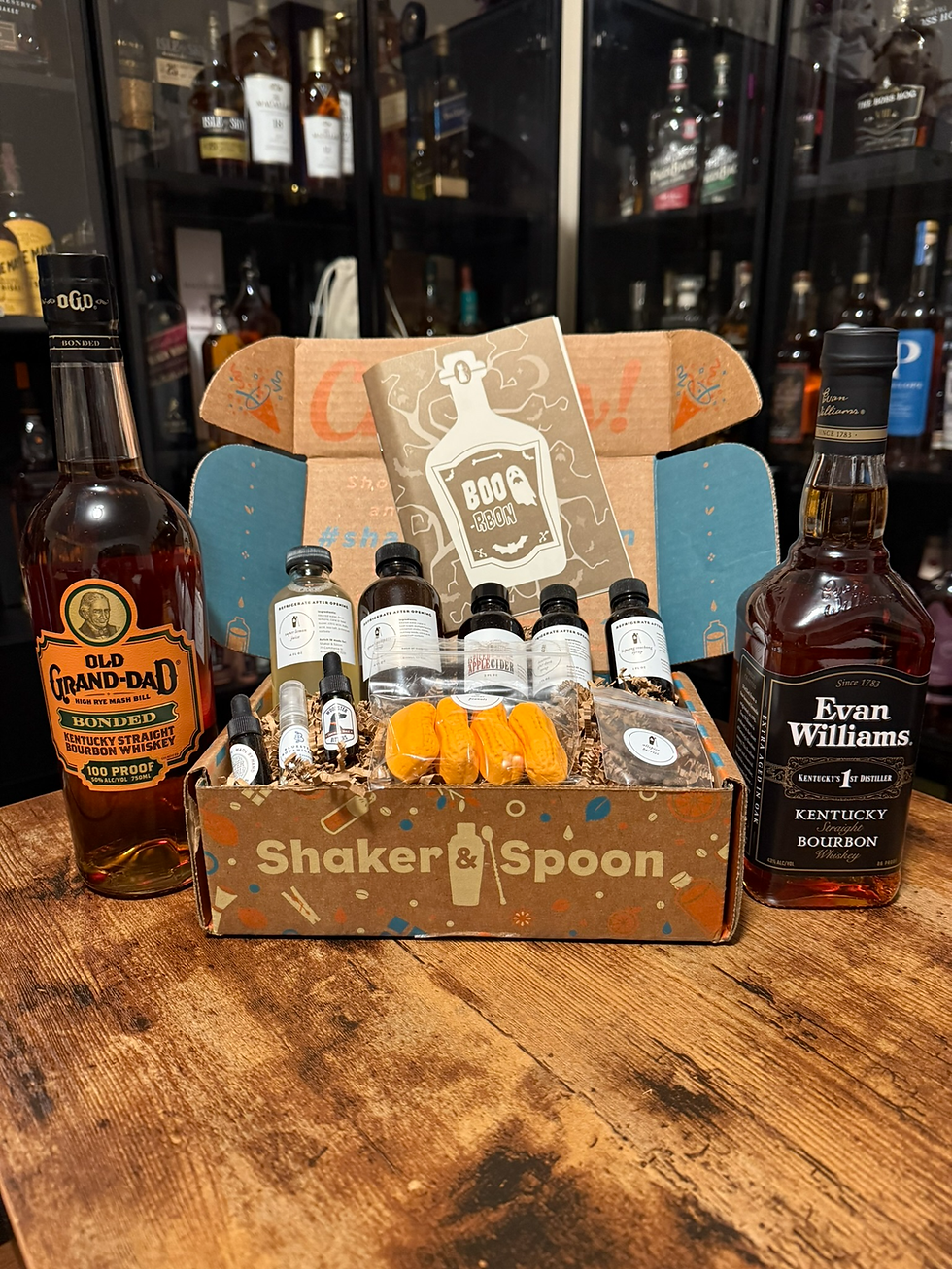Bourbon gift box with Old Grand-Dad and Evan Williams bottles, Boo-Rbon card, and small tasting bottles on a wooden table.