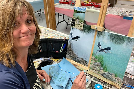 Artist applying oil paints to a canvas, depicting a still life scene with fruit and a vase.