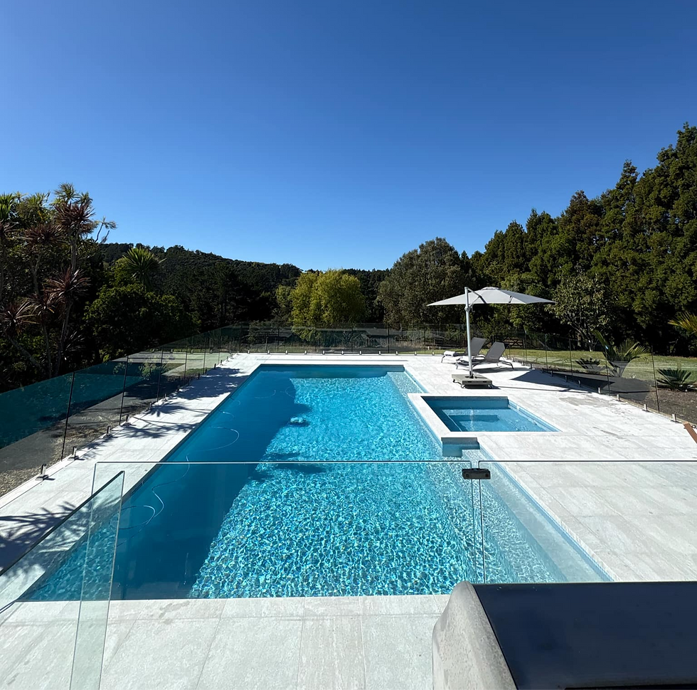 High-angle view of a refurbished concrete pool with clean water and new interior finish.