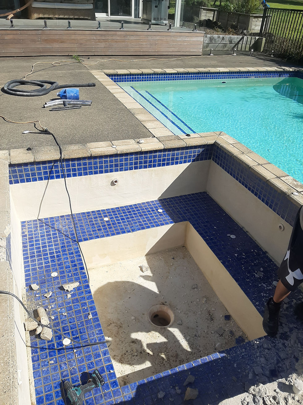 Close-up view of cracked concrete and old pool plaster after surface removal.