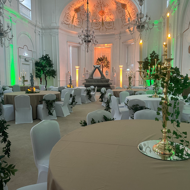 The Chandelier Suite at the Assembly Rooms Newcastle set for a formal event with decorated tables, chandeliers, and atmospheric lighting.