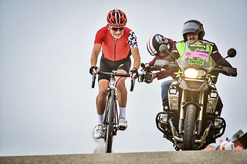 Cyrielle filming a cycling race on a motobike