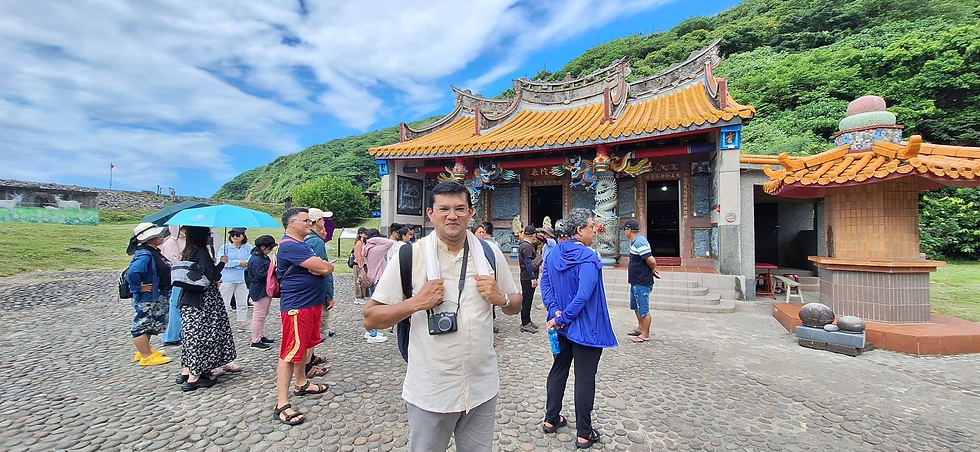 Fr. Liju Kuriath behind a Buddhist Temple
