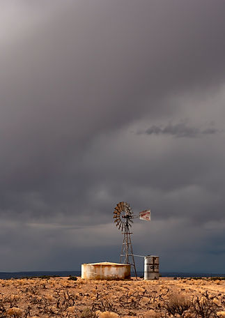 Storm clouds rising over a windmill along Hovenweep Road, Utah, USA