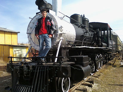 Highschool graduate poses on steam engine locomotive at New Braunfels Railroad Museum by GoodShiz