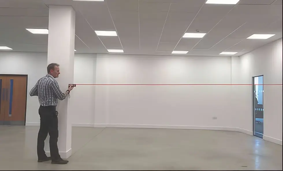 man measuring an building with a laserwebp