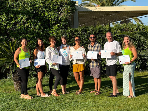 Group of yogis receiving their yoga certificates