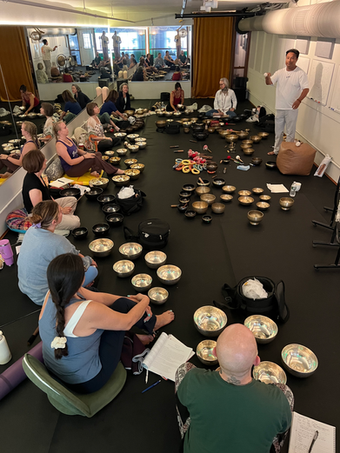 Students with singing bowls for a West Wind Yoga immersion.