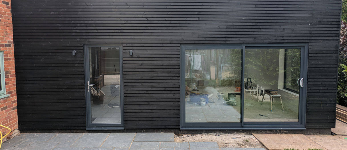 This Modern SIPs extension has hard clean lines that contrast the old house it adjoins