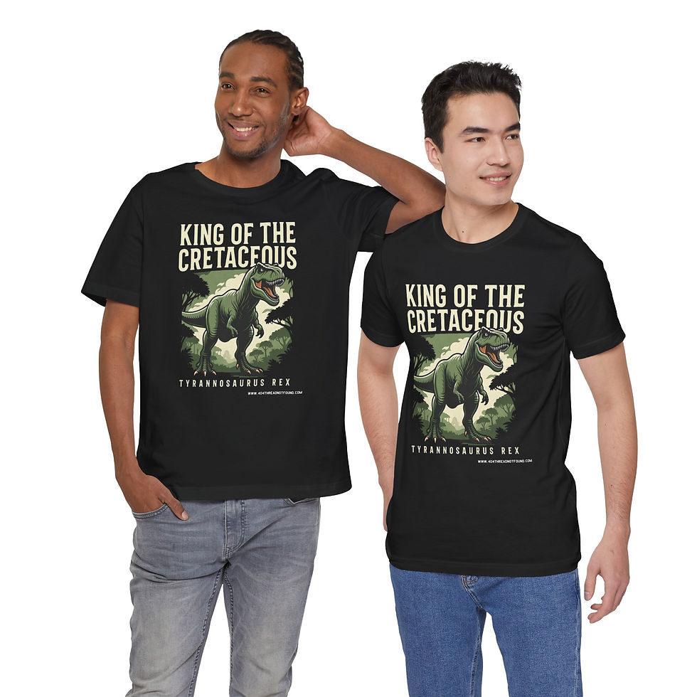 Thumbnail: Two models wearing king of the cretaceous green T-Rex shirt. Cream text is unreadable on white and light gray shirts.