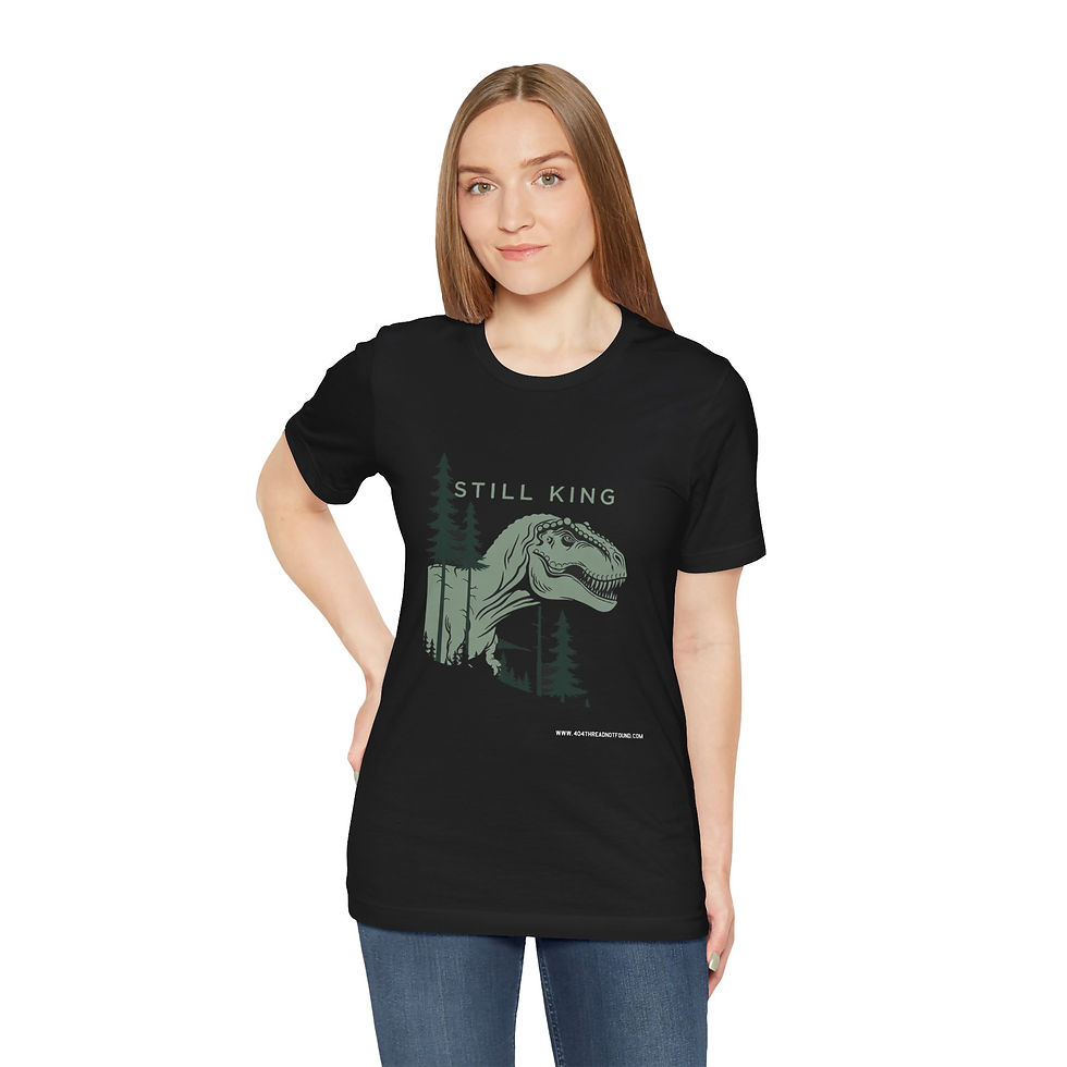 Thumbnail: Model wearing Still King slogan dinosaur T-shirt.