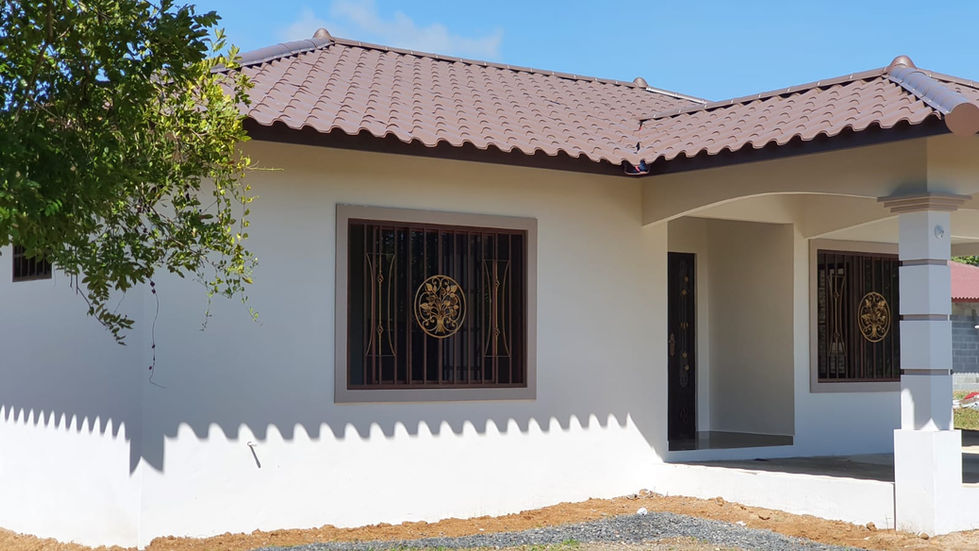 a white house with a brown roof and a window