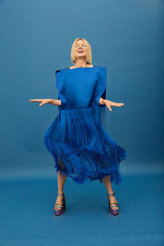 Sophisticated celebrity post-production for InStyle. Naomi Watts dancing in blue feathered dress against blue background.