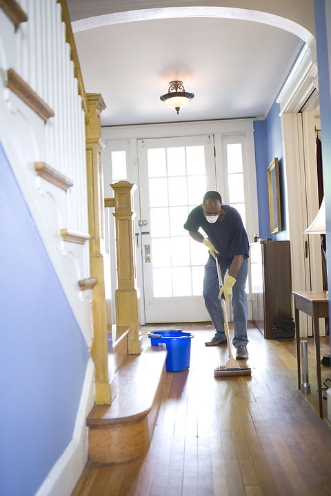 Man mopping a floor space