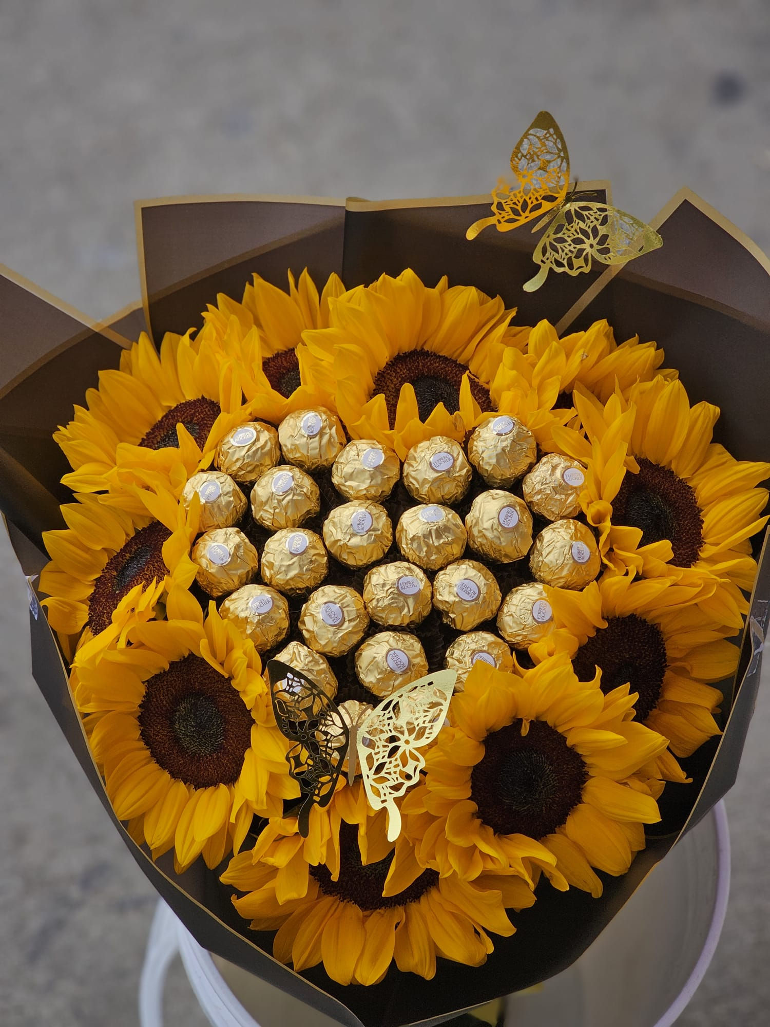 Beautiful bouque of Premium Sunflowers and Chocolate wrapped in Black Paper