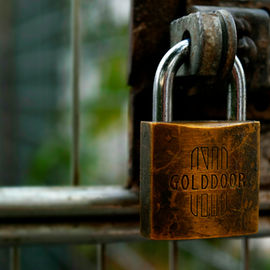padlock on gate symbolizing privileged access management (PAM)