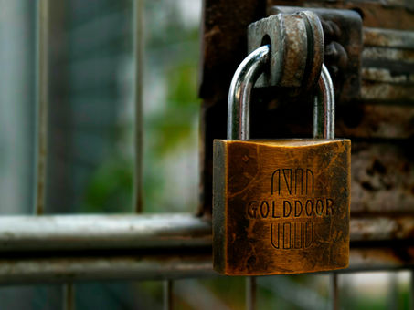 padlock on gate symbolizing privileged access management (PAM)