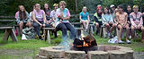 Campers at closing campfire having fun