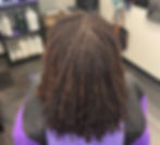 Eye-level view of a woman with microlocs in a stylish setting