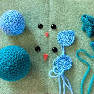 Deconstructed crochet birds on green felt