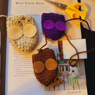 in progress owls flat with felt circles on top of flattened crochet