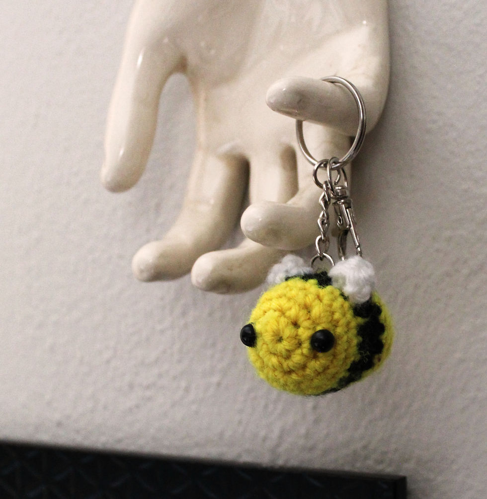 Thumbnail: Bumble Bee Keychain Hanging from Ornamental Hand Statue