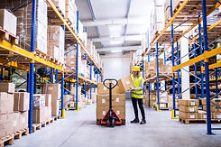 Female warehouse worker loading or unloa