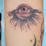 blackwork tattoo of eye with sun rays