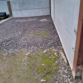 an old outdoor hardcore bay area that the client wanted to turn into a concrete bay, metal panels to right side and back