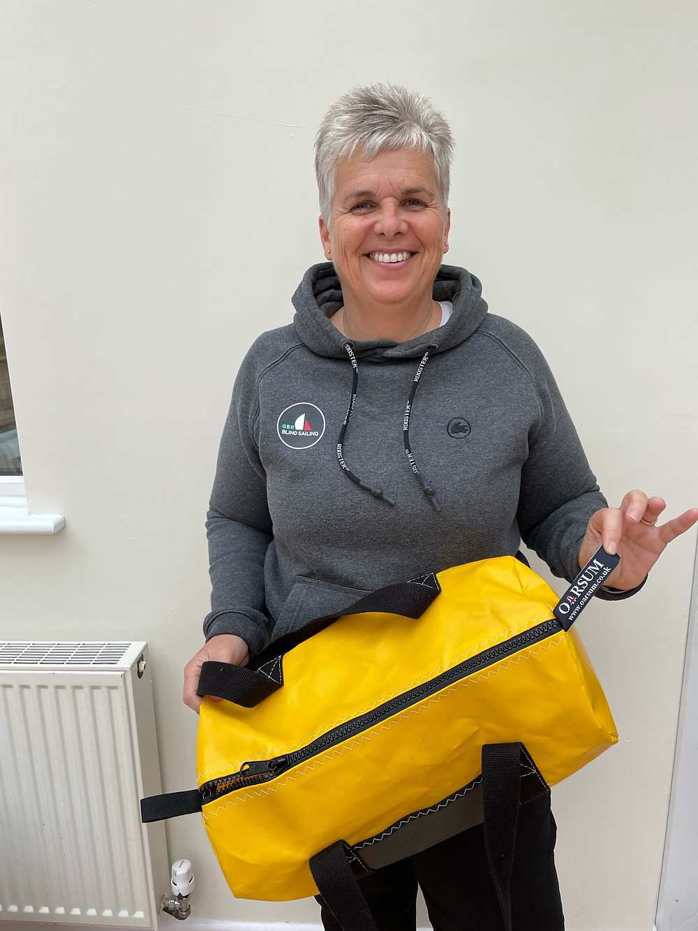 Judith with her day 1 winning bag from Oarsum all made out of yellow sail cloth.