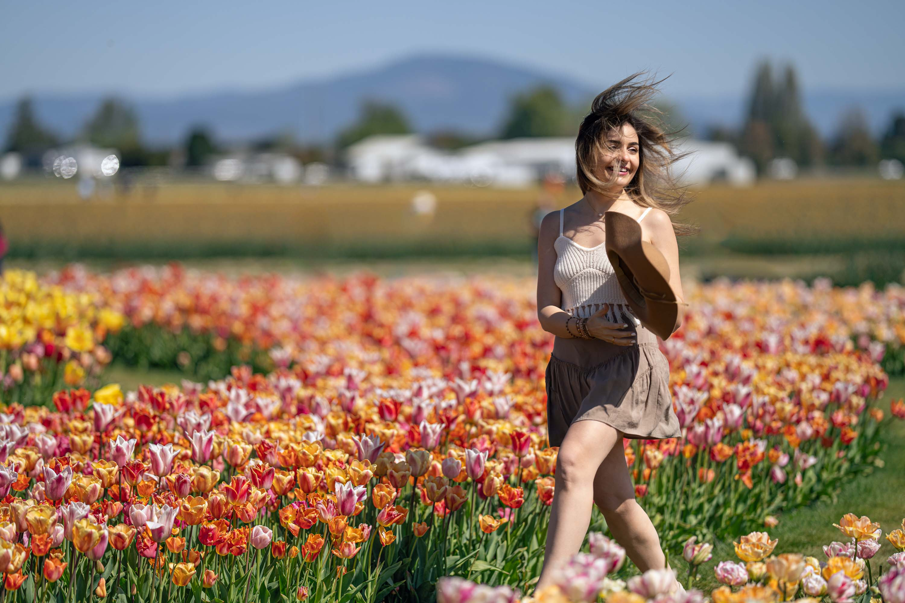 Smiling woman in colorful tulip field at Tulip Festival