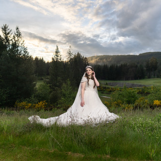Bride in white gown in a scenic field, Gold Mountain Golf Club Weddings