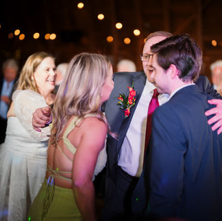 Guests socializing at a lively evening reception with bokeh lights.