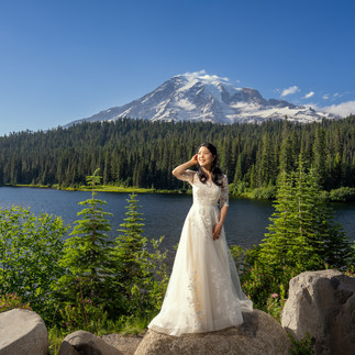 Bride at her Mount Rainier elopement by a mountain lake.