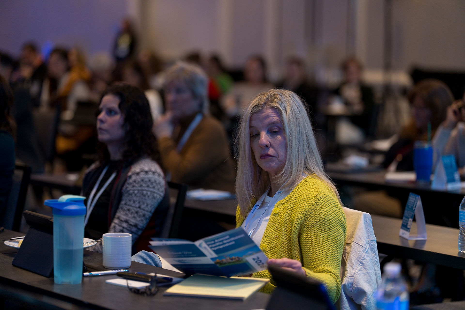 Woman reading program at IBD Pro event, Seattle Event Photography