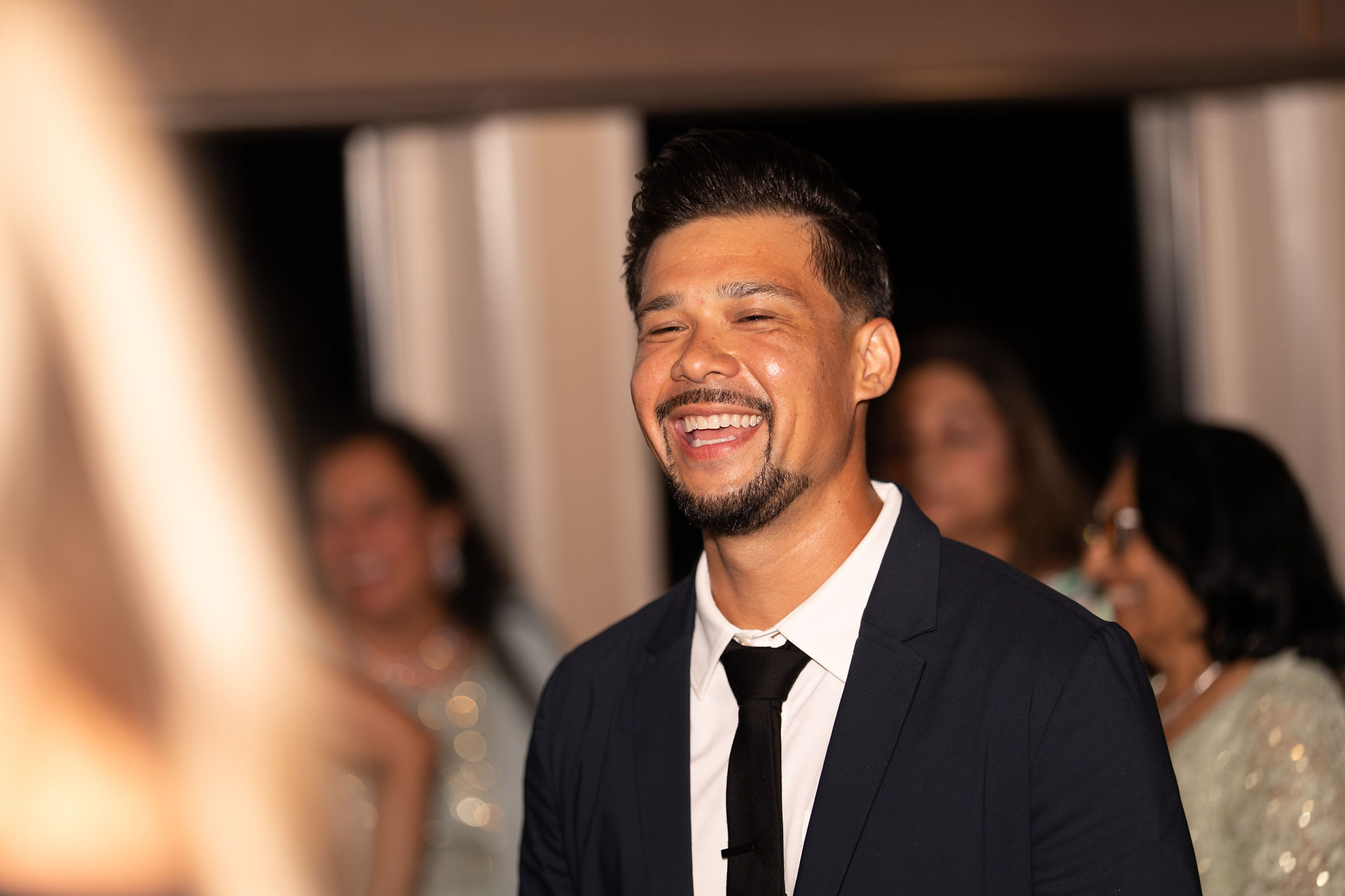Groom laughing at a Pacific Northwest wedding reception.